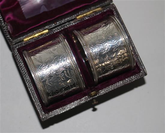 A cased pair of Victorian engraved silver napkin rings.